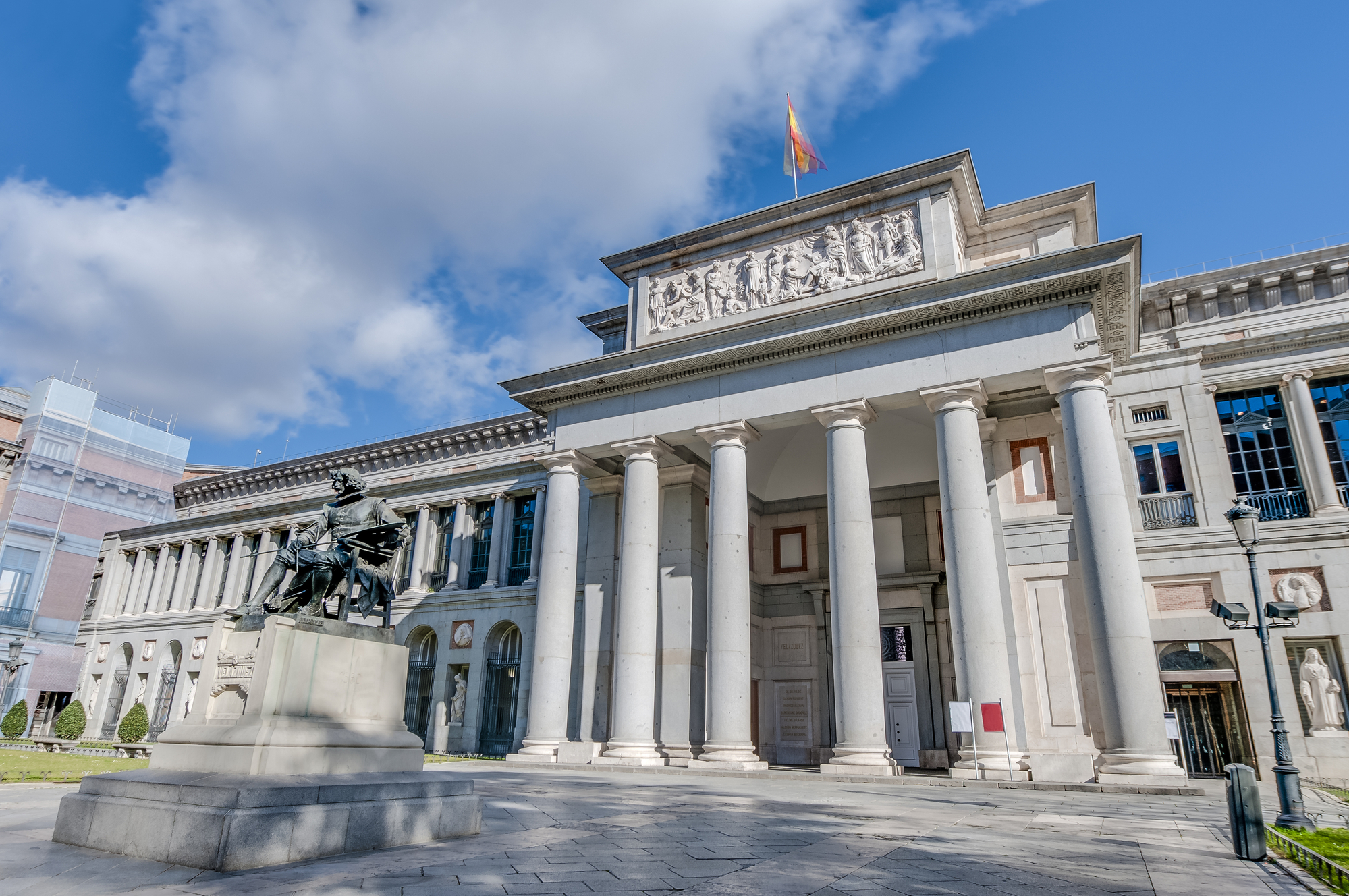 Prado Museum facade and Cervantes statue in Madrid, Spain